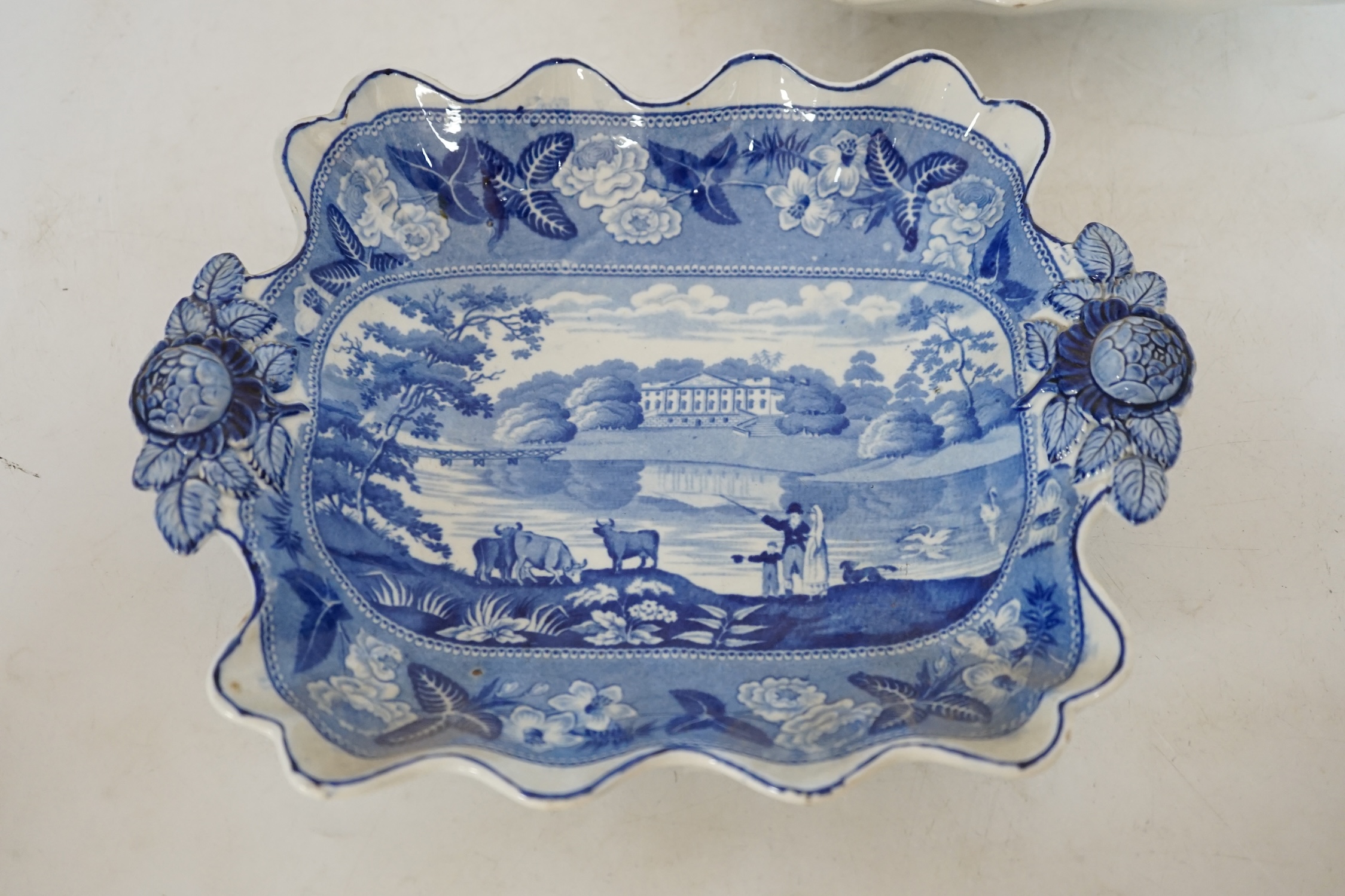 A pair of 19th century ‘British Scenery’, dessert dishes, with floral decorated handles, 24cm wide. Condition - good